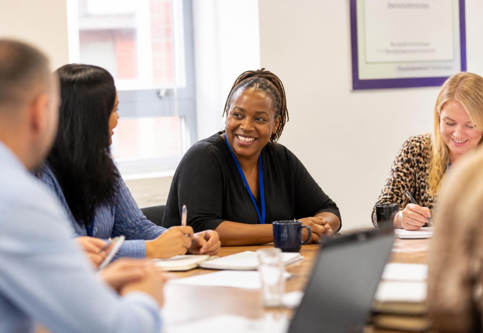 A diverse team of public sector professionals in a training discussion